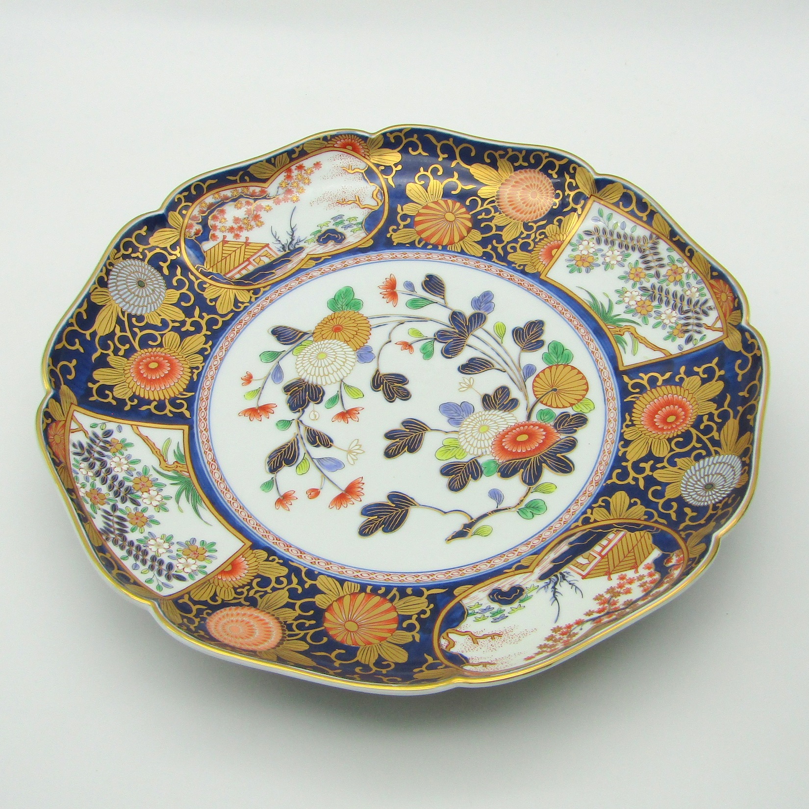 Japon. Plat en porcelaine à décor polychrome de fleurs et paysages, XXe