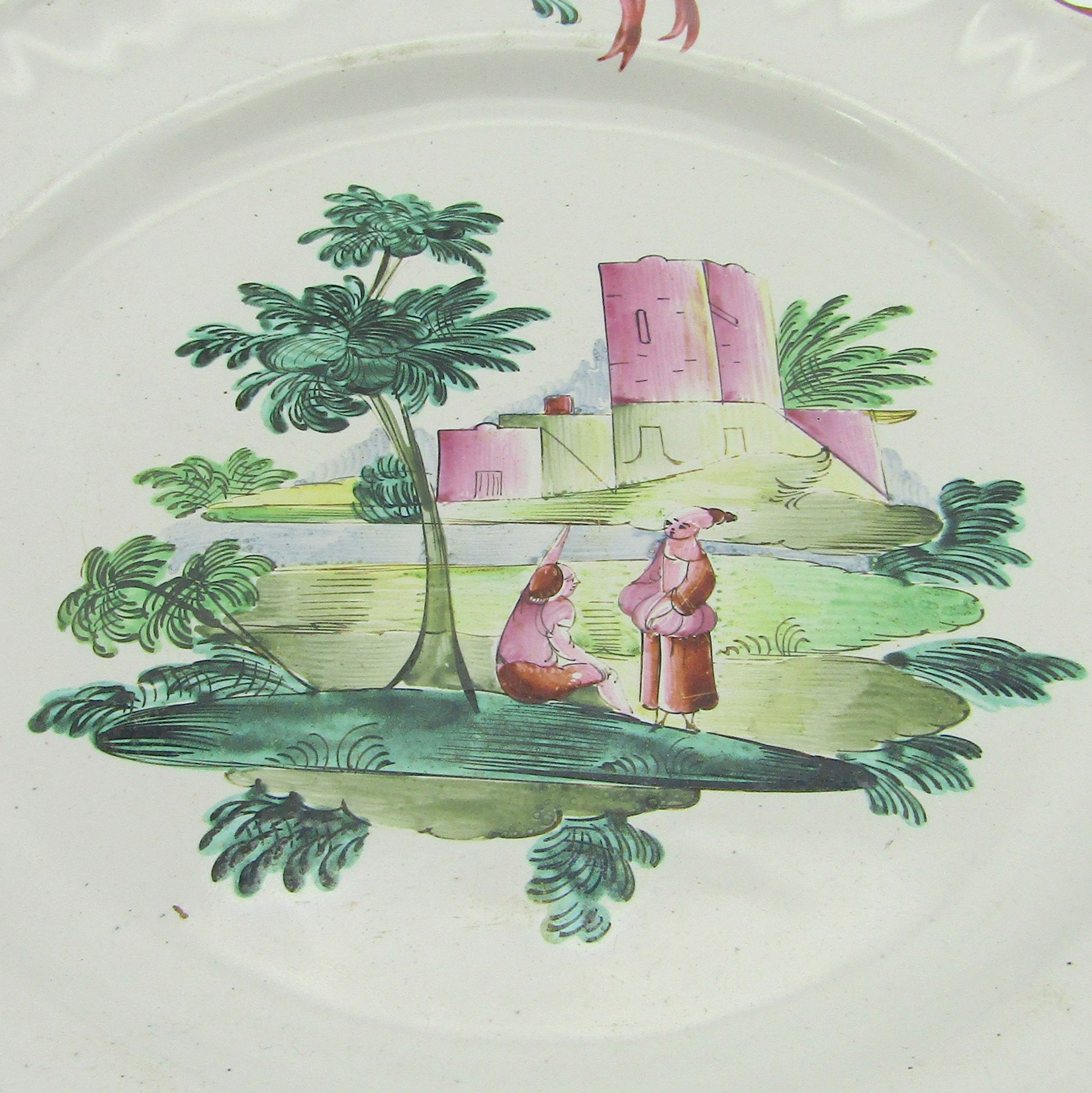 Moustiers ou Varages. Assiette en faïence à décor de deux personnages dans un paysage, XVIIIe siècle