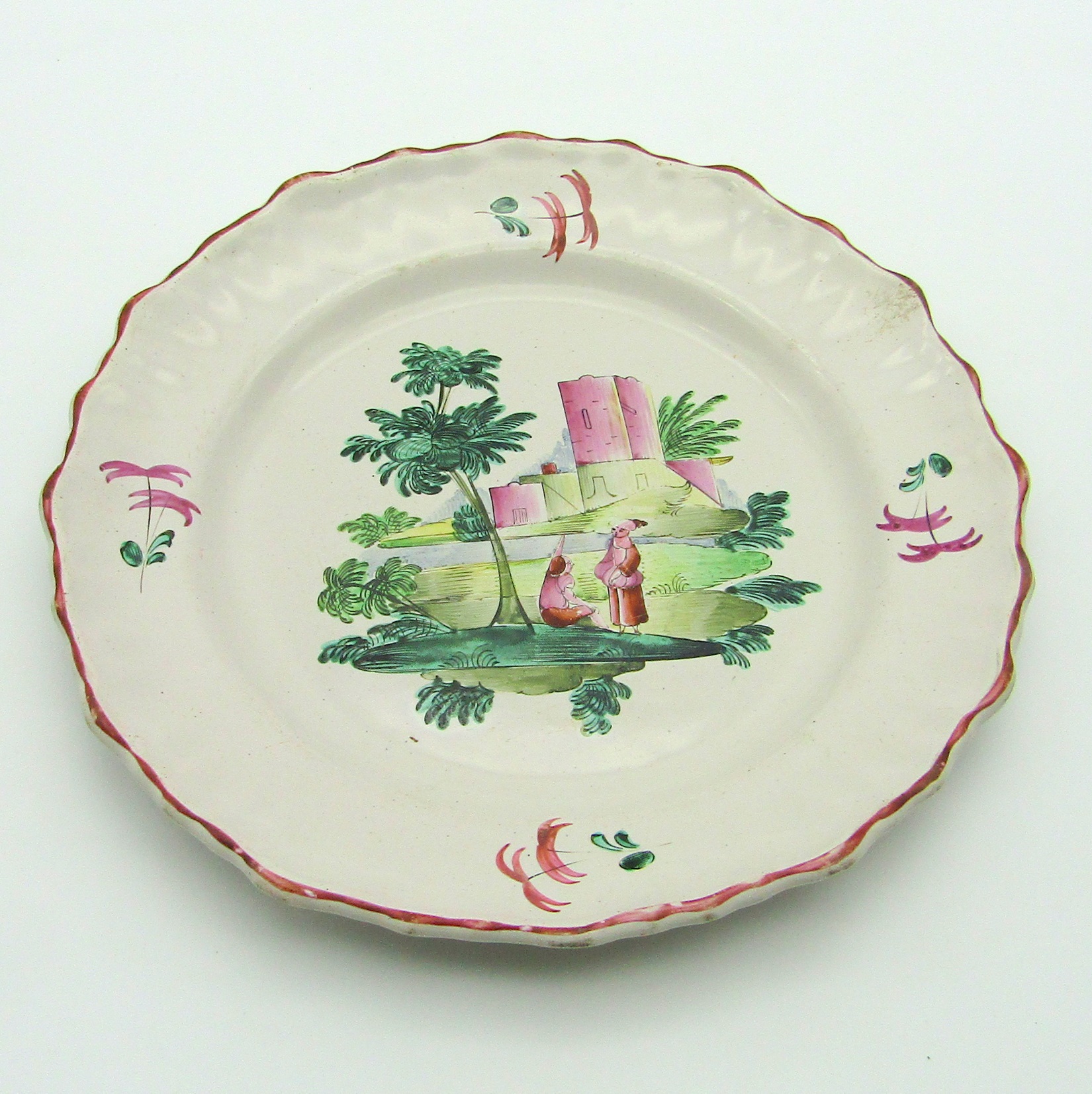 Moustiers ou Varages. Assiette en faïence à décor de deux personnages dans un paysage, XVIIIe siècle