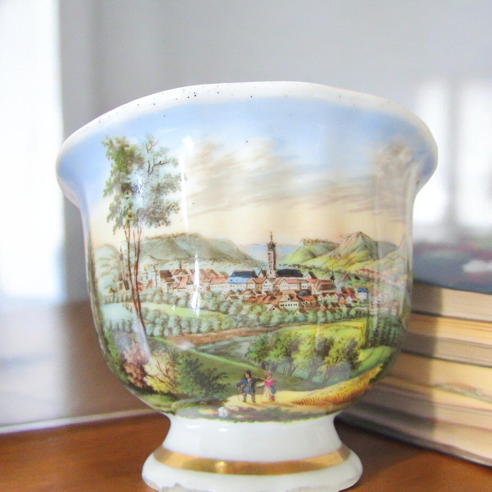 KPM Berlin. Tasse en porcelaine à décor polychrome de paysages, début XXe siècle