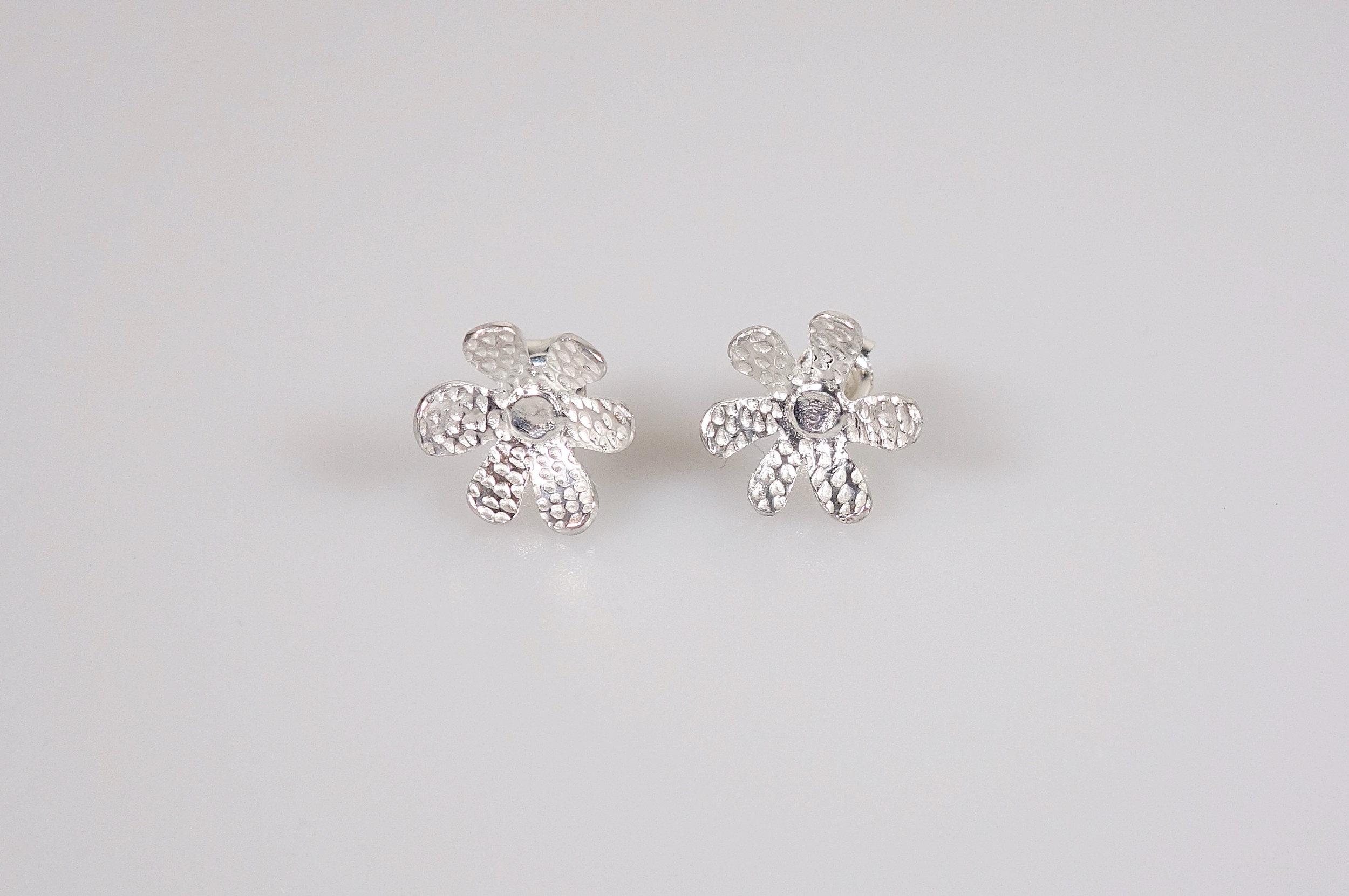 Boucles doreilles fleur &quot;Pointillisme&quot; en argent massif ciselé, vue de face sur fond blanc