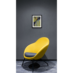 Trendy_fabric_chair_next_to_spotlit_wall