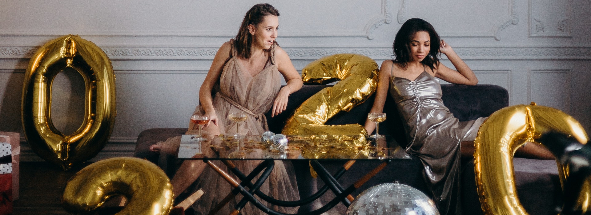 photo of women sitting on couch near disco ball 3402535