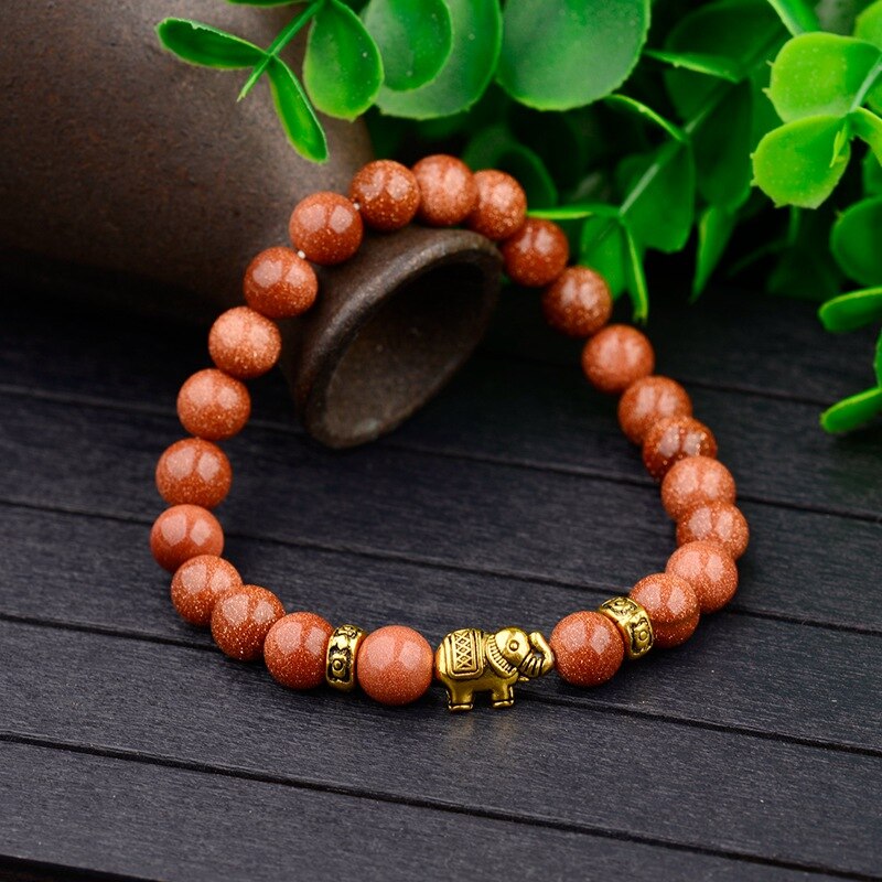 bracelet avec perles en bois et éléphant doré