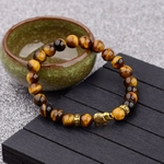 bracelet avec perles en bois et éléphant doré