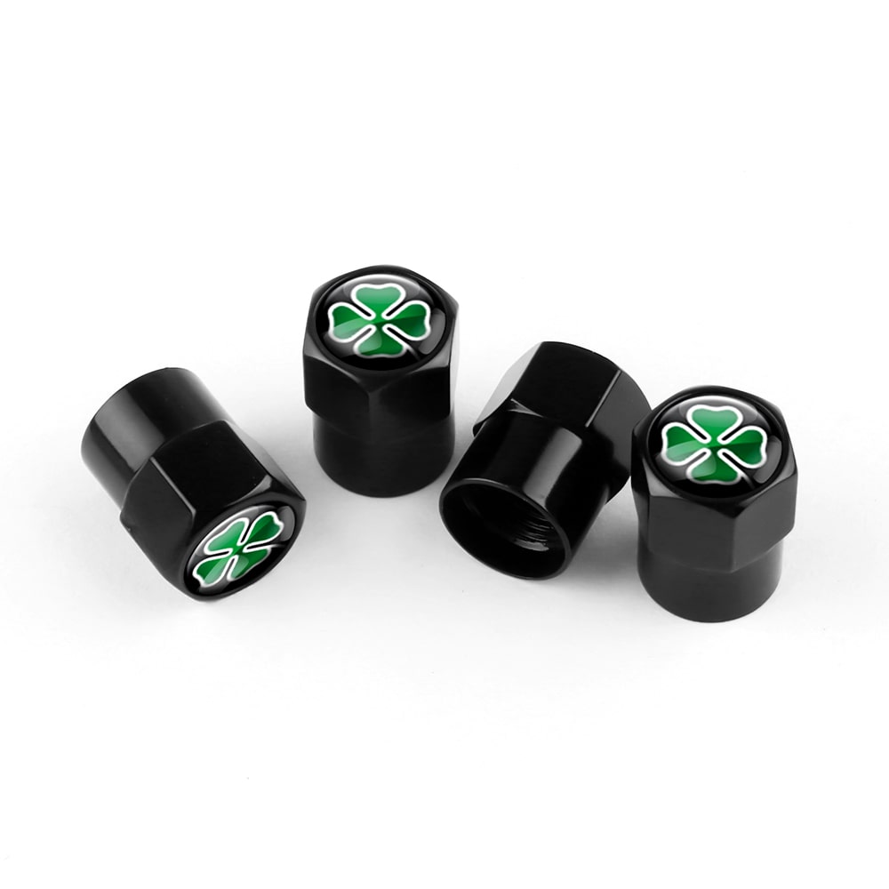 Lot de 4 bouchons de valve noirs Quadrigoglio sur fond blanc.