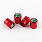 Ensemble de 4 embouts de protection pour valve rouges Quadrigoglio sur fond blanc.
