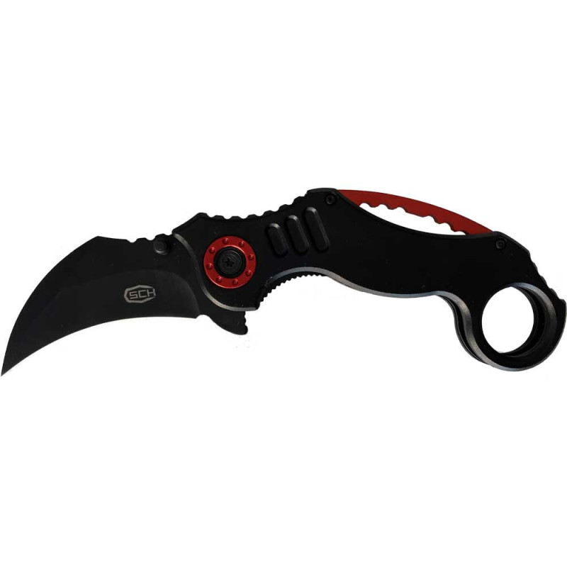 Karambit pliant ouvert : lame courbe noire marquée SCK, manche noir à entretoise rouge et anneau