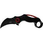 Karambit pliant ouvert : lame courbe noire marquée SCK, manche noir à entretoise rouge et anneau