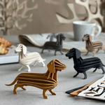 Trois figurine 3D qui representent des teckels