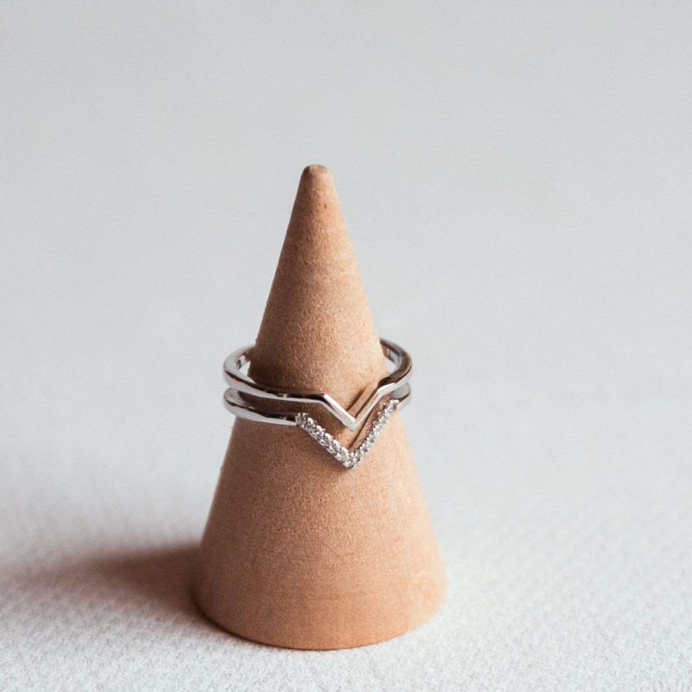 bague double anneau argent motif en v avec strass exposee sur cone en bois estelle
