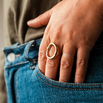 bague epaisse ovale acier dore reglable et portee majeur gauche main dans poche de jean suzie