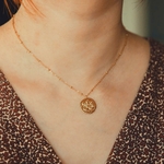 collier pendentif medaillon frappe avec  une balance representant le signe astrologique porte