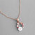 Collier pendentif couleur or rose, fleur blanche, papillon or rose, et cristaux colorés
