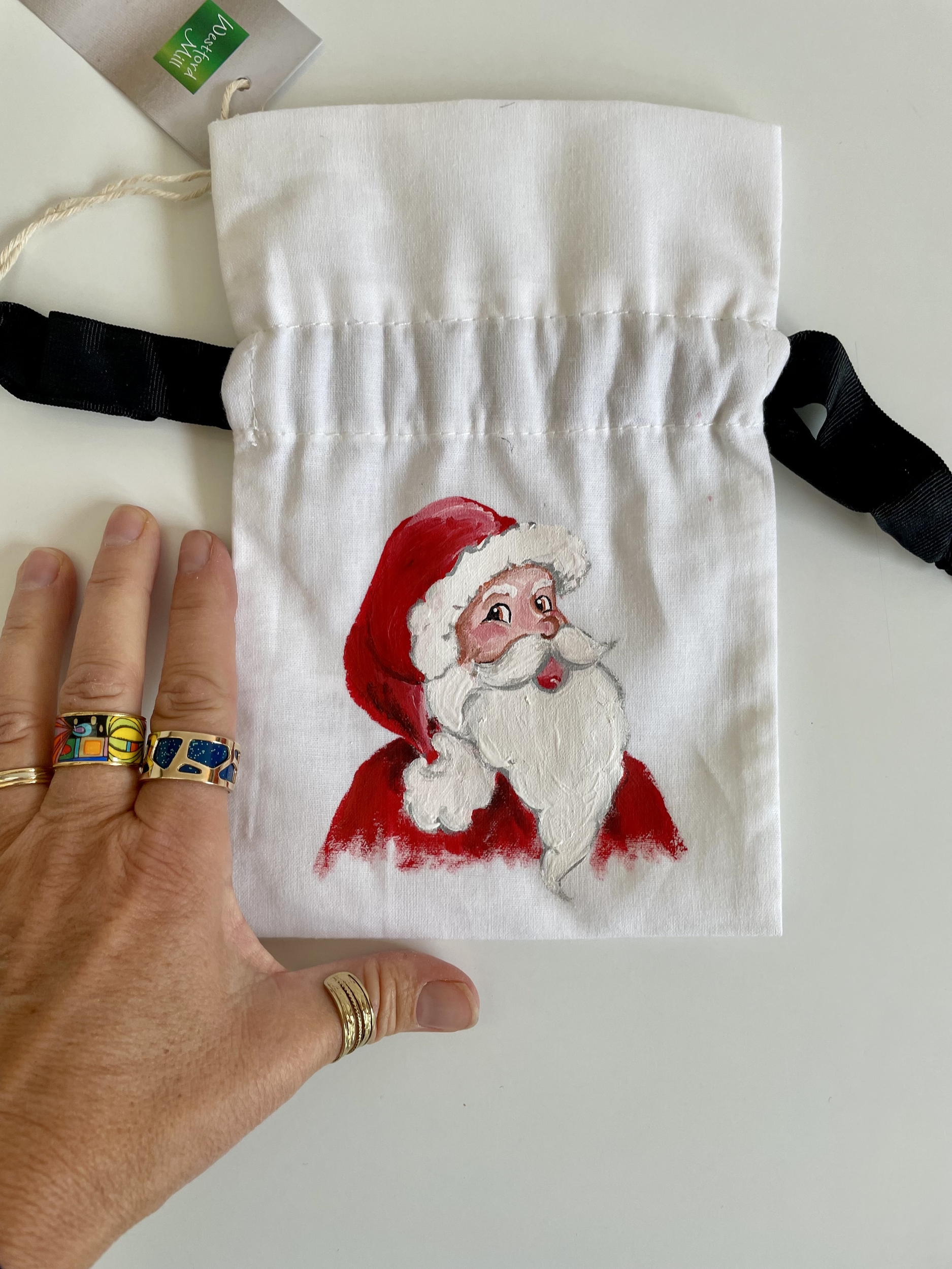 Pochette coton blanc, ruban satin noir, avec tête de père Noël peinte à la main par Elles et No.