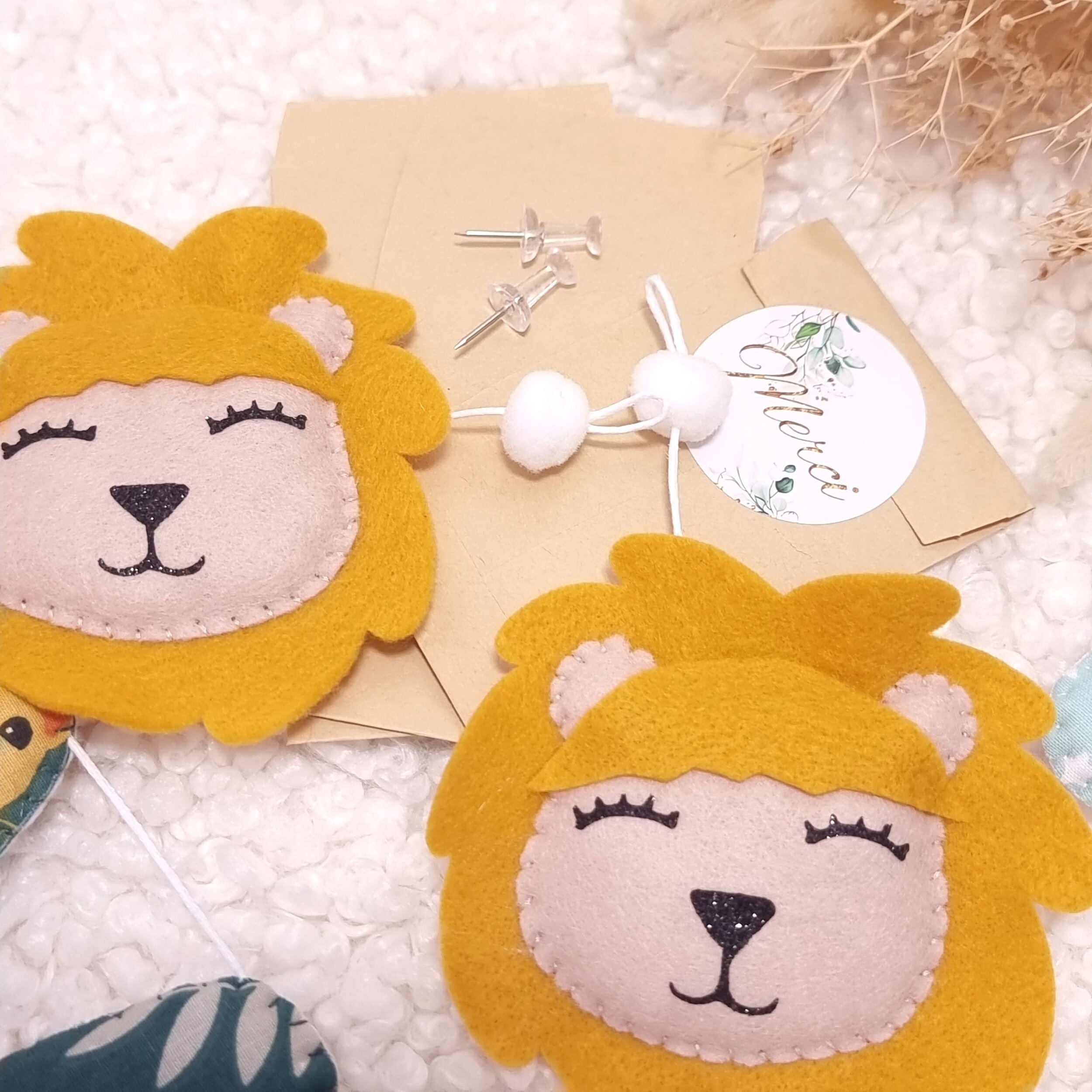 Têtes de lion en feutrine et petites punaises pour fixation guirlande prénom