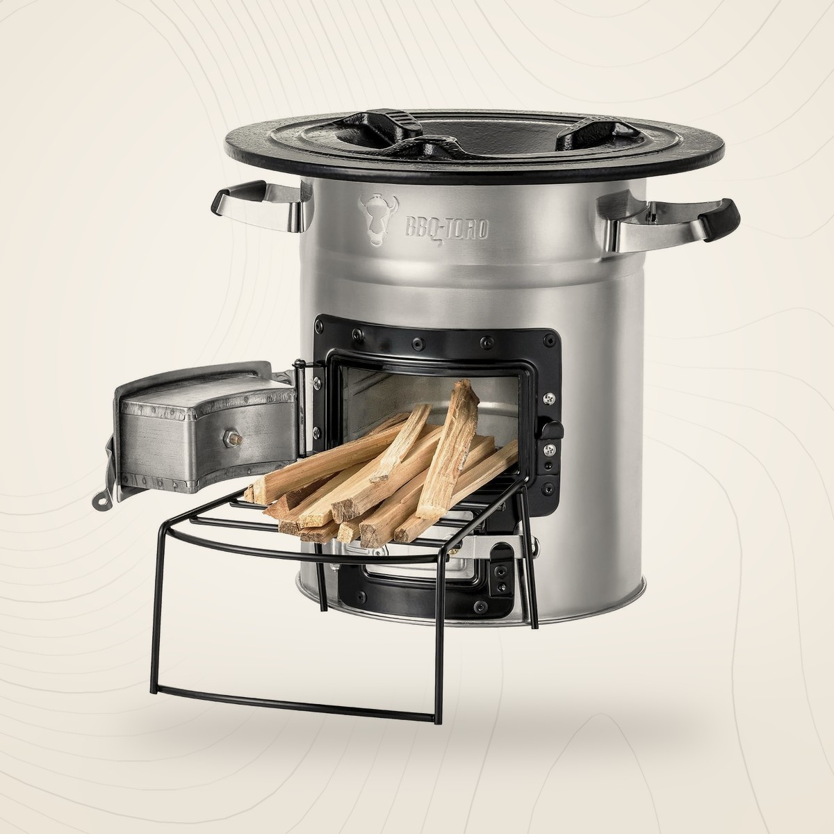 Réchaud à bois fusée BBQ-Toro en inox avec support à bois, sur fond lin