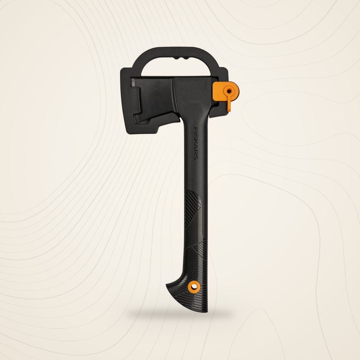 Hachette Fiskars Solid A6 dans son étui de transport noir, manche FiberComp noir et orange, sur fond lin