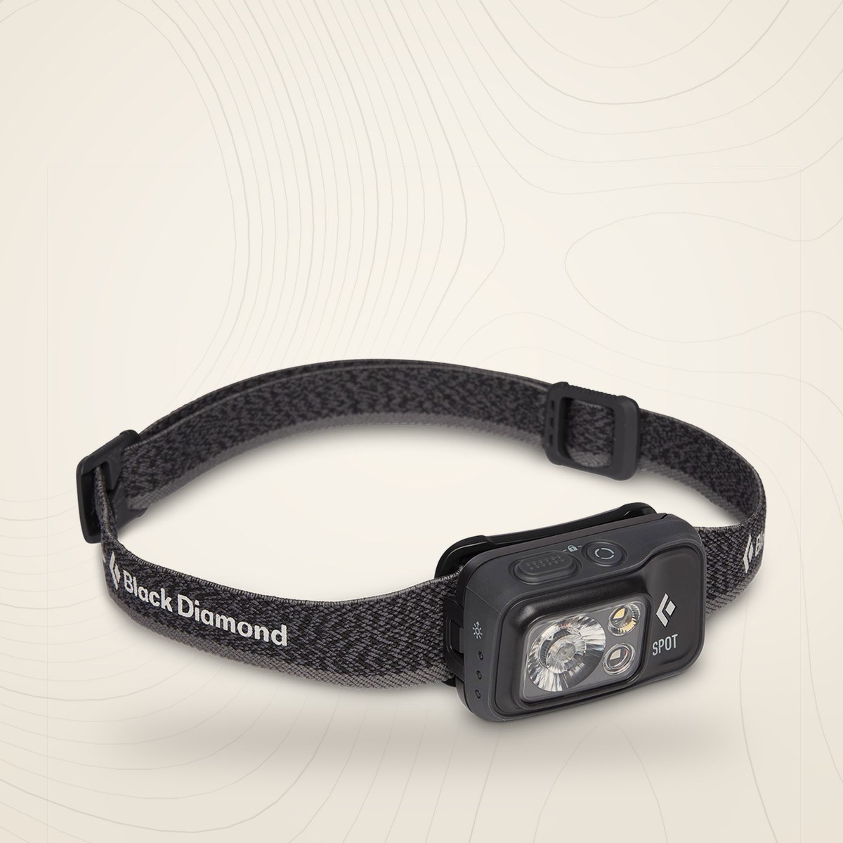 Lampe frontale Black Diamond Spot 400 graphite avec son bandeau élastique réglable, sur fond lin