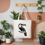 Tote bag femme avec illustration d’un oiseau toucan flocage noir suspendu à une patère - MARJANE et Cie