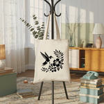 Tote bag femme avec illustration d’un oiseau colibri monochrome noir suspendu à un porte manteau - MARJANE et Cie