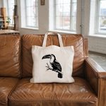 Tote bag femme verso avec illustration d’un toucan en dessin monochrome noir posé sur un canapé - MARJANE et Cie