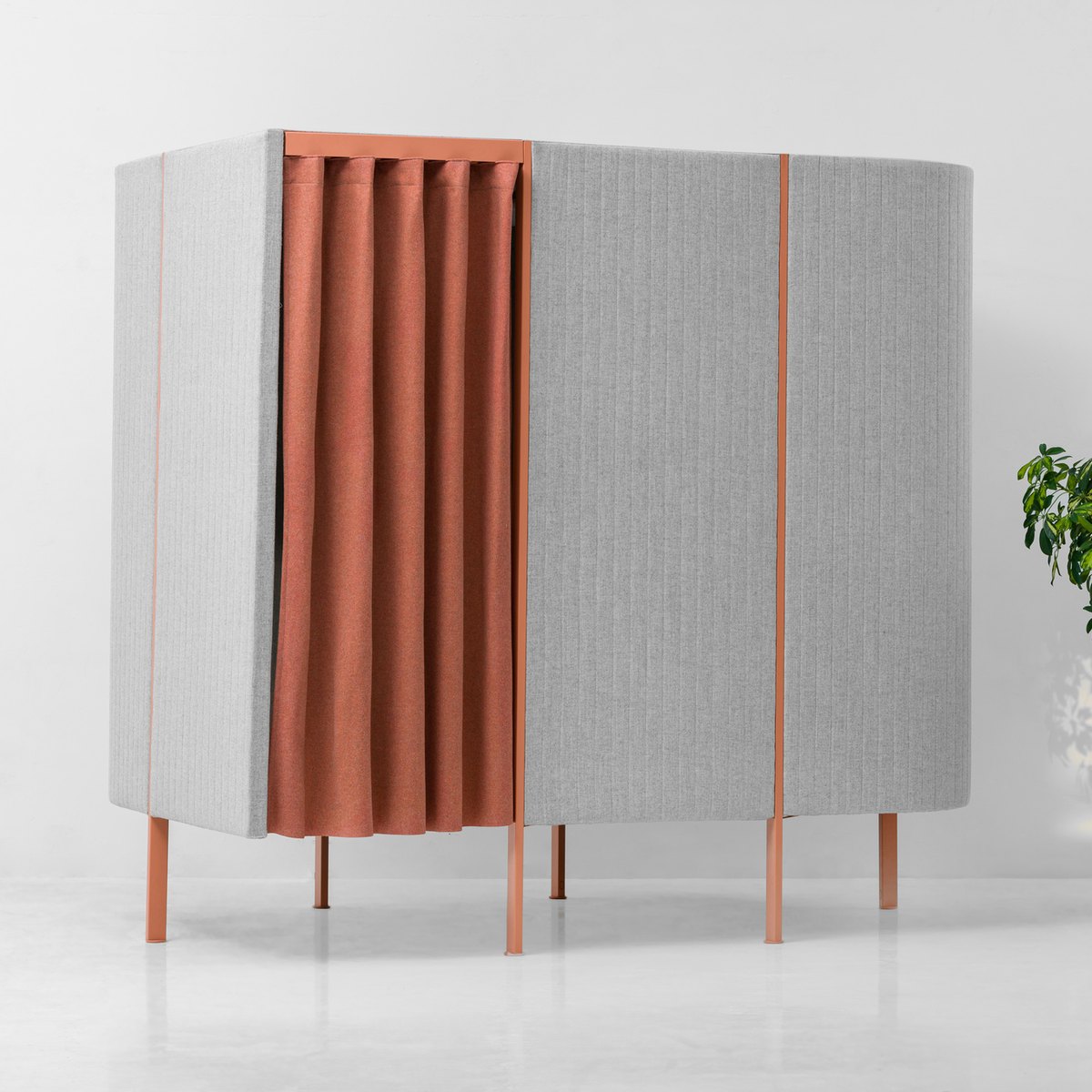 Cabine acoustique individuelle en tissu gris clair fermée par un rideau terracotta