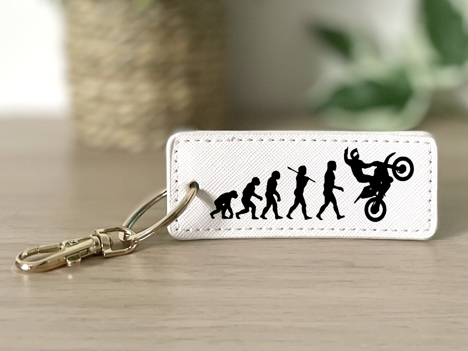 Porte clés évolution homme wheeling blanc