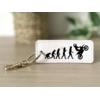 Porte clés évolution homme wheeling blanc
