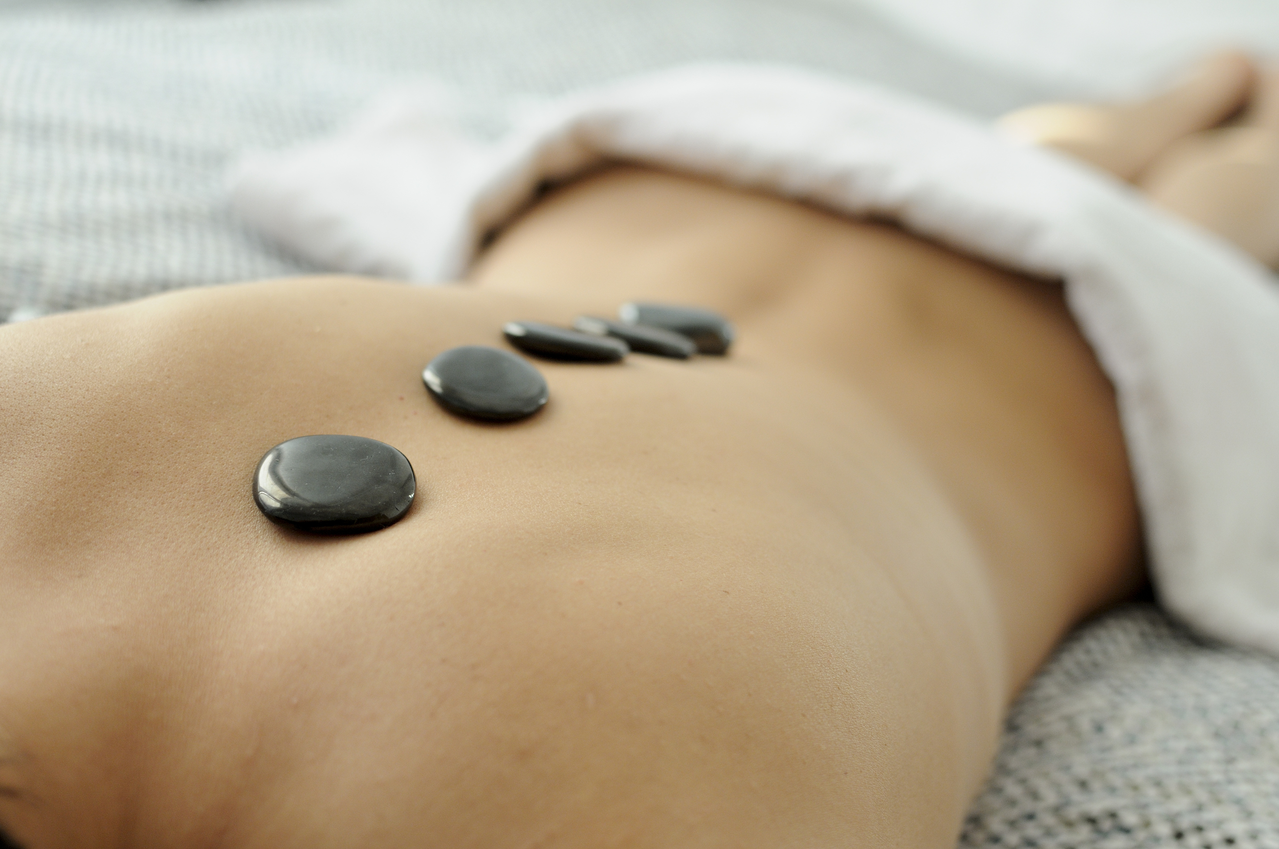 close-up-of-woman-s-back-with-hot-stones-treatment