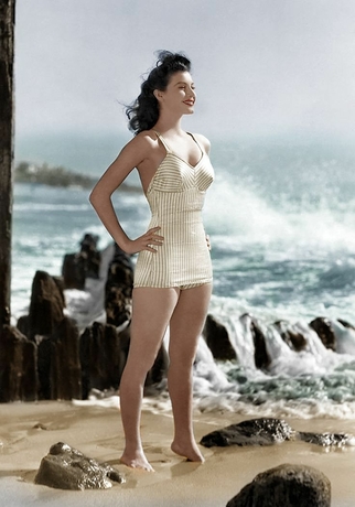 Ava Gardner in striped swimsuit on the beach, embodying classic grace and beauty, an inspiration for the Sahra.Nko collection.