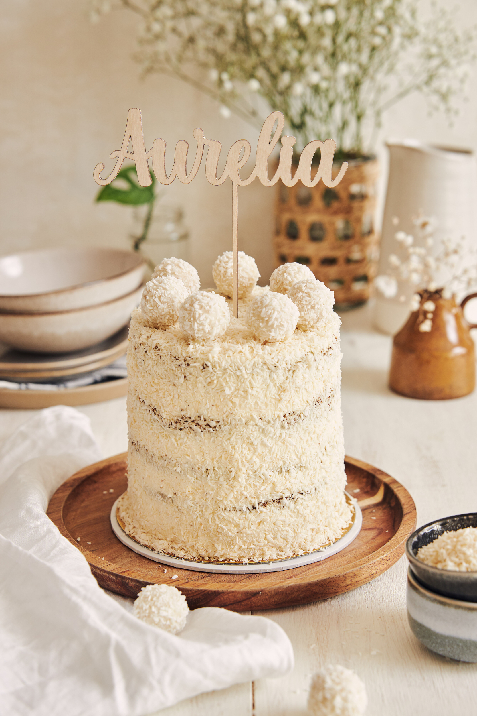 delicious-birthday-cake-woman-named-aurelia-with-coconut-flakes-raffaello-balls