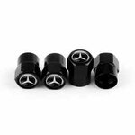 Front view of four black Mercedes valve caps showing emblems and threaded interior