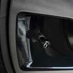 Black Mercedes valve cap installed on a wheel valve