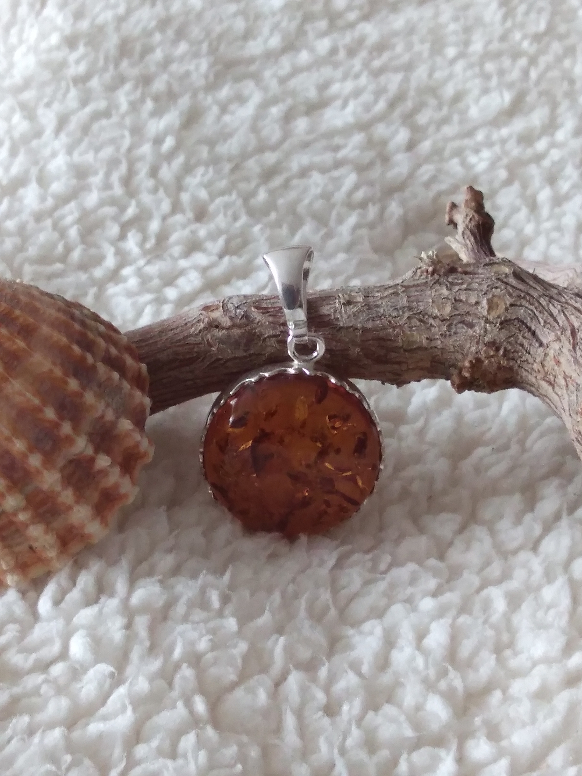 Pendentif rond en ambre cognac véritable et argent 925°/°°.