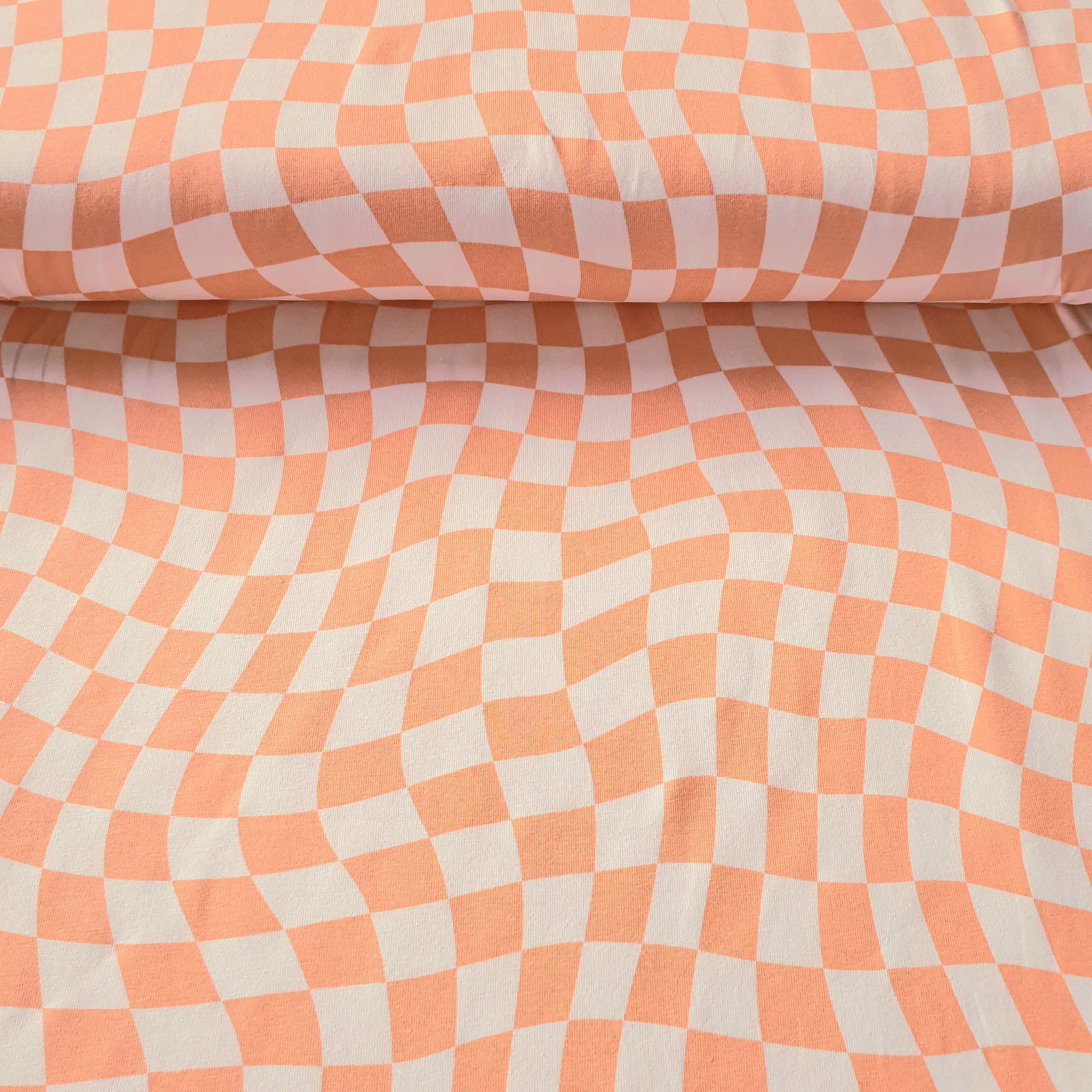 Tissu jersey damier asymétrique saumon et blanc