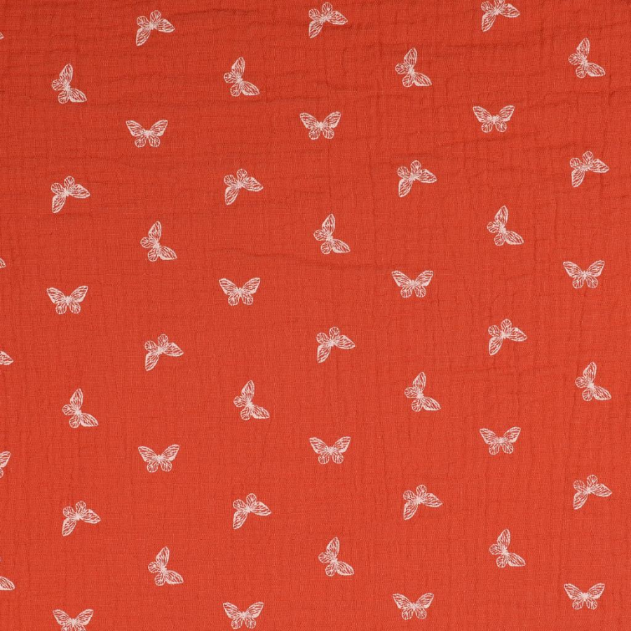 Tissu double gaze orange papillon blanc