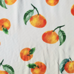 Tissu jersey coton avec fruit orange sur fond blanc