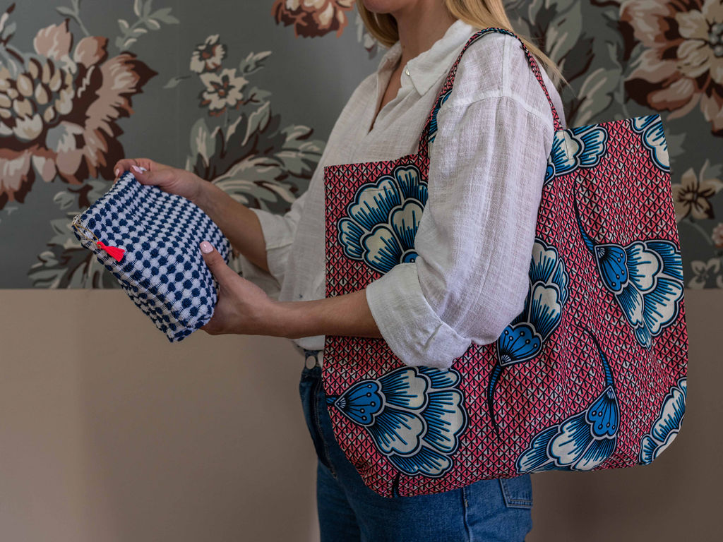 jeune femme avec un sac rose et bleu à lépaule et manipulant une pochette en éponge