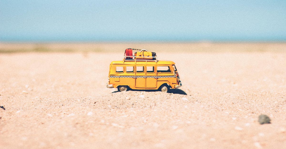 yellow die cast miniature van on brown sand