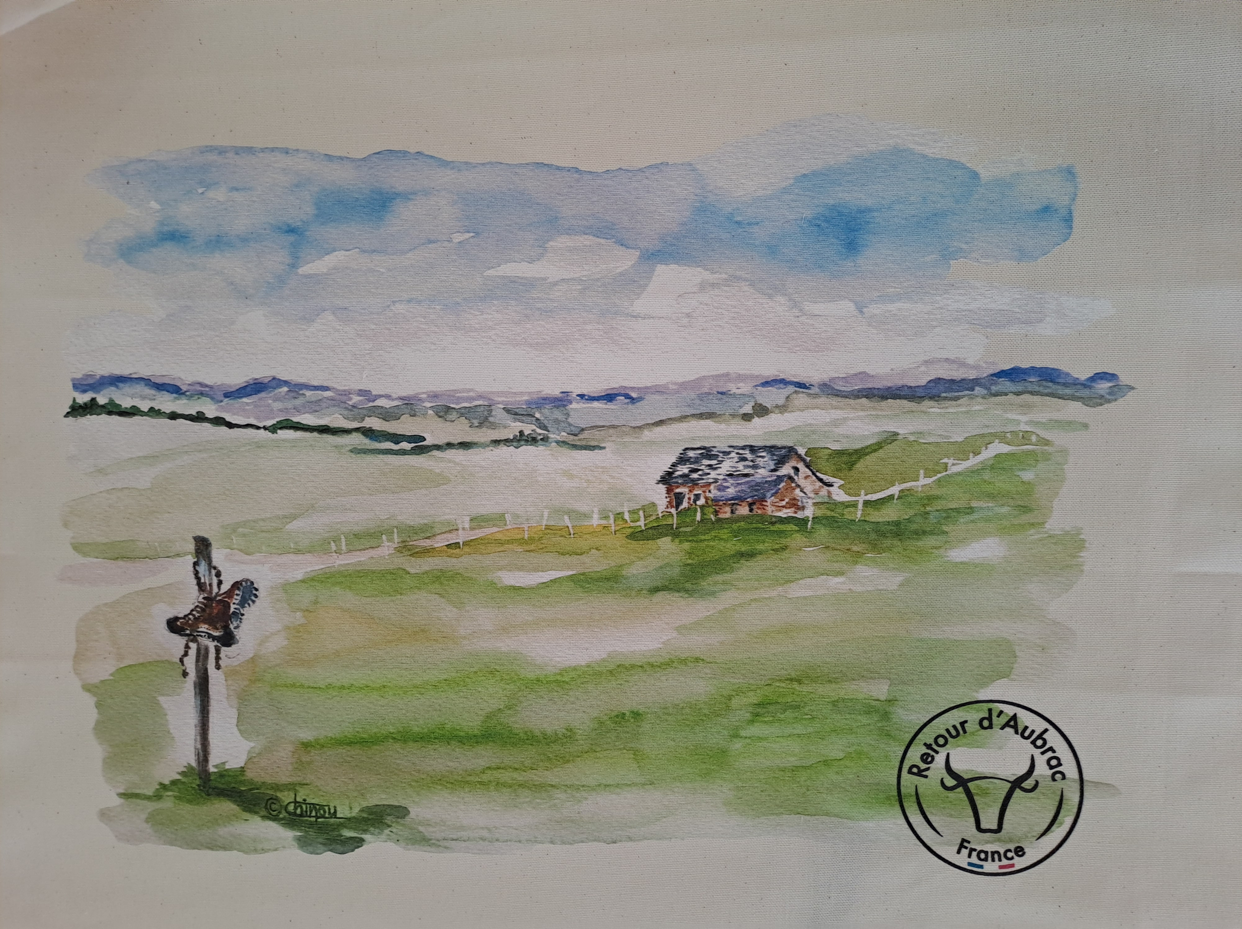 Torchon Aveyron représentant le plateau de l’Aubrac avec un buron, des clôtures en pierre et des chaussures de randonnée- Retour d’Aubrac-Aveyron-cadeau français-1