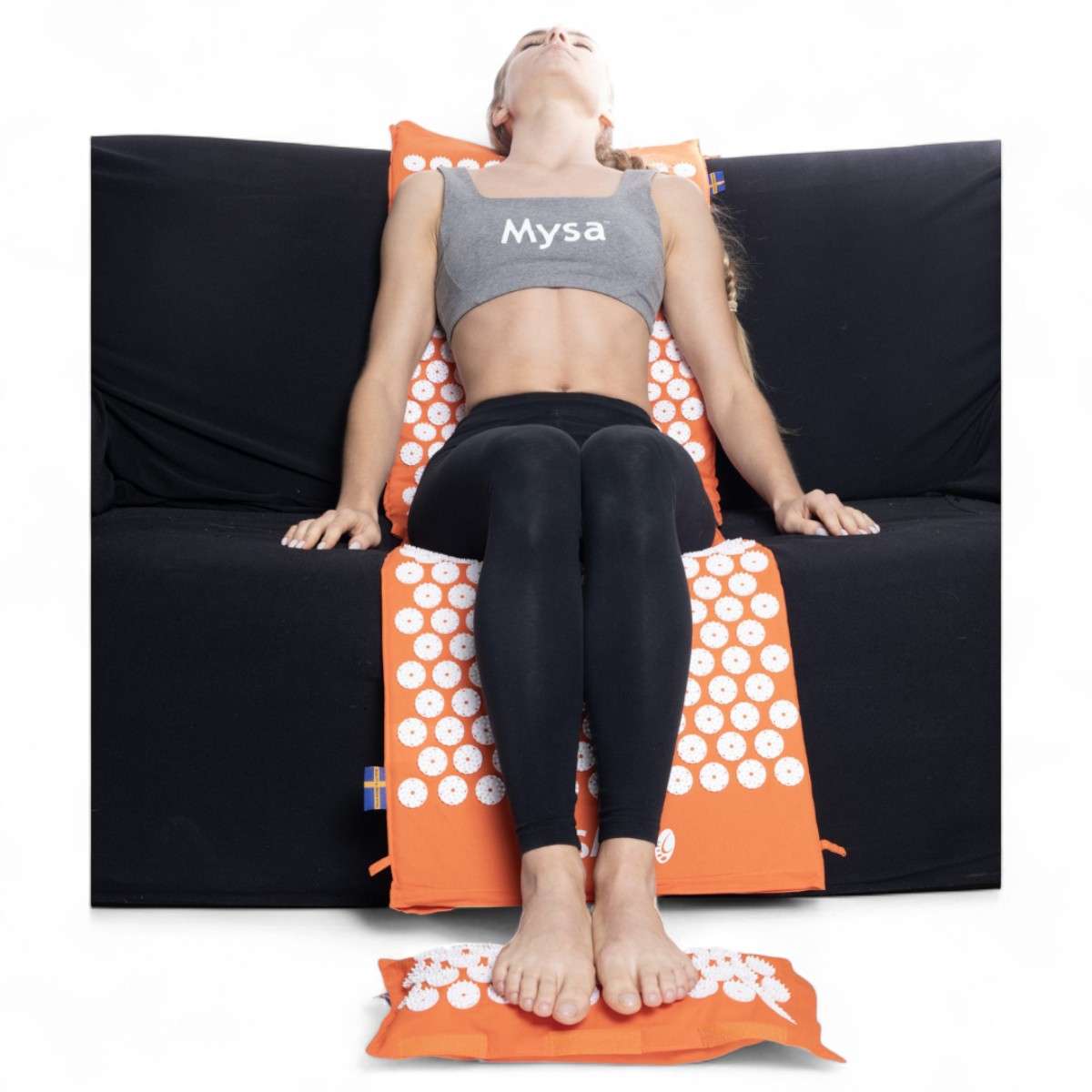Séance d’acupression sur canapé avec le ThermoMag Mysa Duo XXL et le coussin chauffant ThermoMag