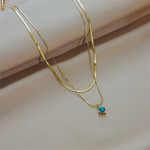 collier-multirang-serpent-et-turquoise-olympe-bijoux-fond-beig