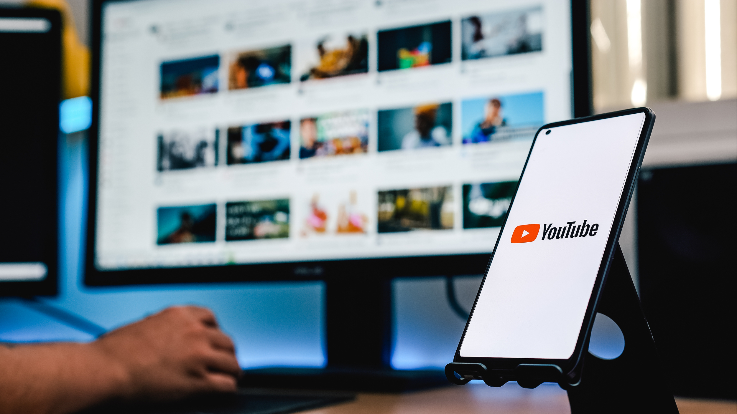 phone-with-youtube-screen-while-person-using-computer