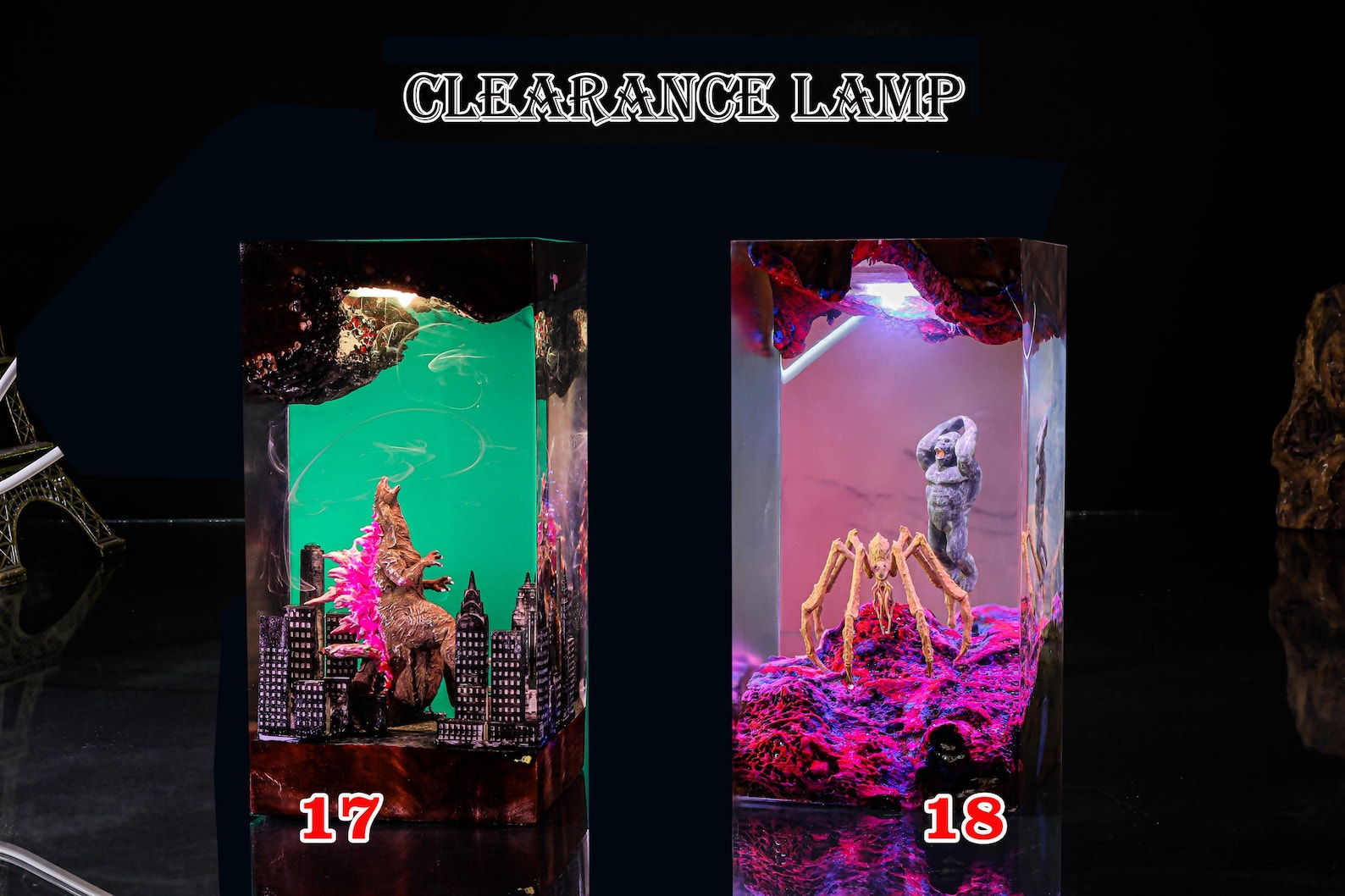 Studio shot of two resin lamps lit in different colors on wooden stands