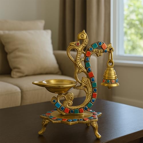 Top-down view of the brass peacock diya showing the oil well and gemstone rims