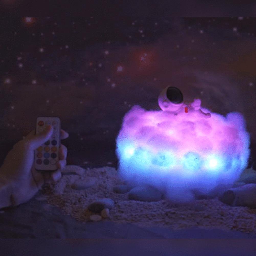 Astronaut night light on desk with soft purple clouds
