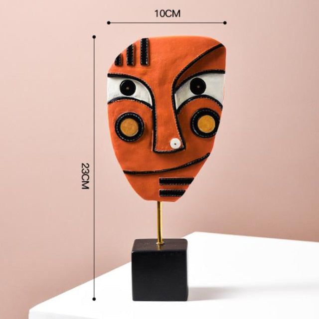 Front view of the colorful face sculpture on a shelf