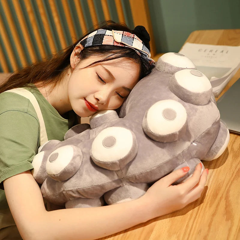 Tentacle pillow draped over a sofa arm