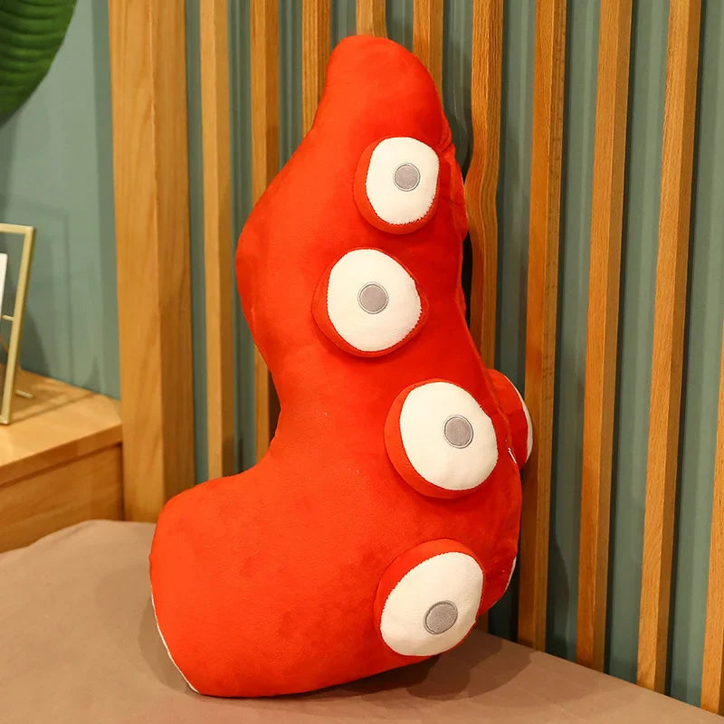 Tentacle plush positioned as a neck rest on travel pillow set-up